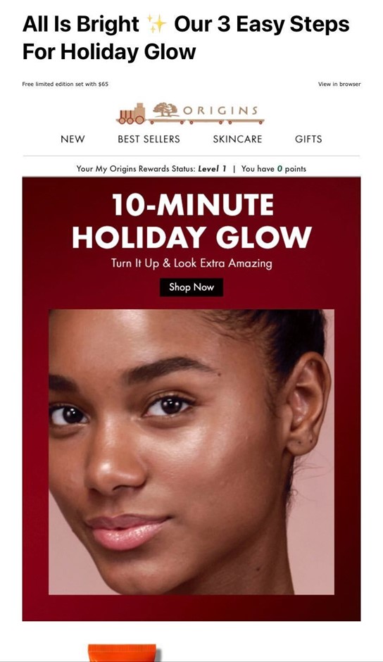 Screen capture of an email from Origins advertising beauty products for a "10-Minute Holiday Glow". Dark red background with white text an image of  a woman's face with glowy skin.